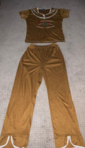 Brown velour two-piece set with crop top and wide leg pants laid flat showing white contrast trim and embroidered graphic